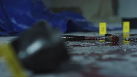 Pull-Focus-Shot-from-Bloody-Hammer-to-Bloody-Shoe-at-Crime-Scene