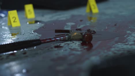 Pull-Focus-Shot-from-Evidence-Tags-to-Bloody-Hammer-to-Shoe-at-Crime-Scene