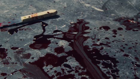 -Close-Up-Gimbal-Shot-of-Knife-and-Blood-at-Crime-Scene