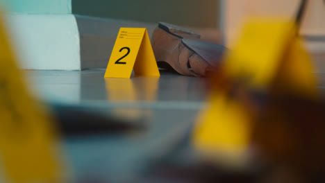 Pull-Focus-Shot-from-Shoe-to-Bloody-Broken-Bottle-at-a-Crime-Scene