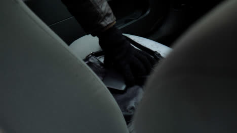 High-Angle-Shot-of-Handbag-and-Cell-Phone-Being-Stolen-from-a-Car-Seat
