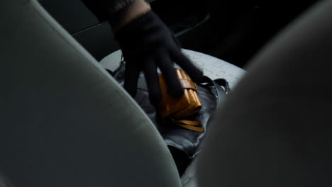 High-Angle-Shot-of-Handbag-and-Purse-Being-Stolen-from-a-Car-Seat