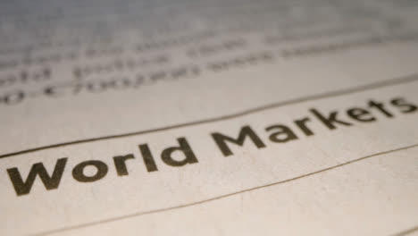 Sliding-Extreme-Close-Up-Shot-of-Newspaper-Print-Saying-World-Markets
