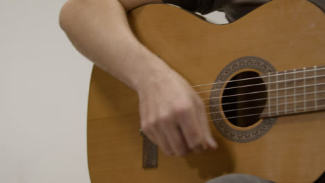 Sliding-Medium-Shot-of-Musician-Playing-Acoustic-Guitar