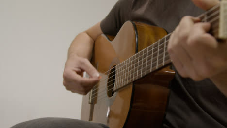 Low-Angle-Shot-of-Musician-Playing-Acoustic-Guitar
