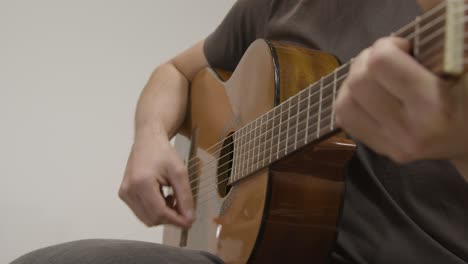 Low-Angle-Shot-of-Musician-Playing-Acoustic-Guitar
