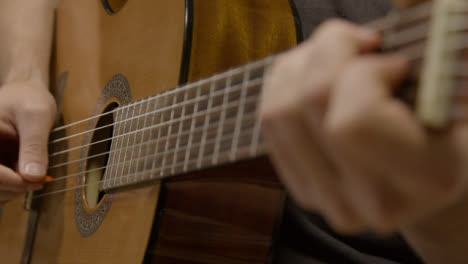 Close-Up-Shot-of-Musicians-Hand-On-Fret-Board-of-Acoustic-Guitar