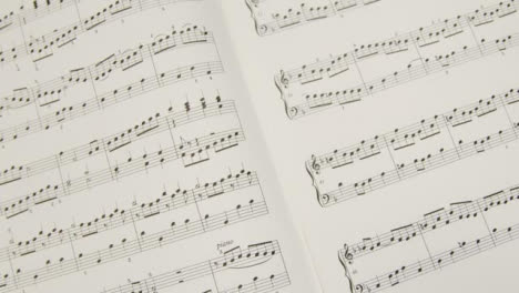 Tracking-Shot-Pulling-Away-from-Music-Sheet-Book