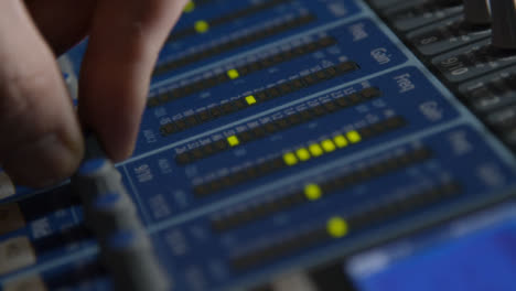 Close-Up-Shot-Tracking-Sound-Mixers-Hand-Pressing-Button-and-Adjusting-Knobs-On-Sound-Board