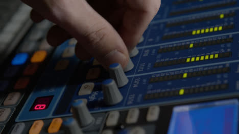 Close-Up-Shot-Tracking-Sound-Mixers-Hand-Adjusting-Knobs-On-Sound-Board