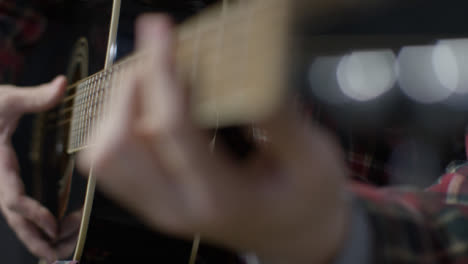 Sliding-Medium-Shot-of-Musician-Playing-an-Acoustic-Guitar