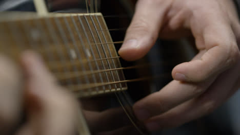 Sliding-Close-Up-Shot-of-Musician-Playing-Acoustic-Guitar