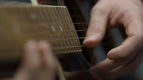 Sliding-Close-Up-Shot-of-a-Musician-Playing-Acoustic-Guitar