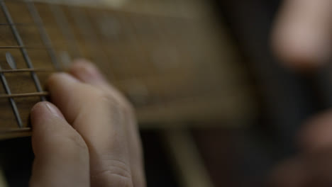 Close-Up-Shot-of-Musicians-Hands-Playing-an-Acoustic-Guitar