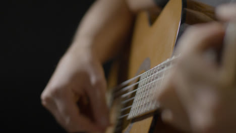 Close-Up-Shot-of-Musicians-Hand-Playing-Acoustic-Guitar-Strings-