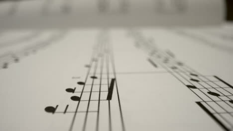 Tracking-Shot-Over-Bars-On-the-Page-of-Music-Sheet-Book