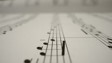 Tracking-Shot-Over-Bars-On-the-Page-of-a-Music-Sheet-Book