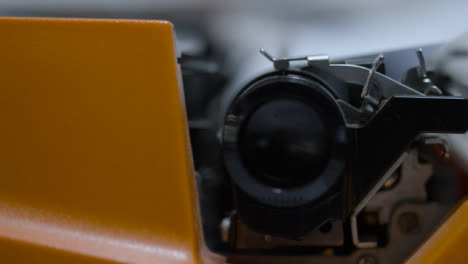 Sliding-Extreme-Close-Up-Shot-of-Typewriter-Carriage-In-Motion-