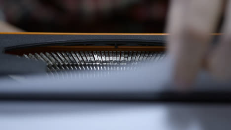 Close-Up-Shot-of-Typewriter-Typebars-as-Writer-Finishes-Typing-and-Pulls-Page