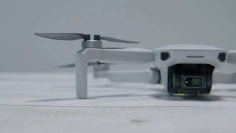 Sliding-Shot-of-DJI-Mini-2-Drone-Sitting-On-Table