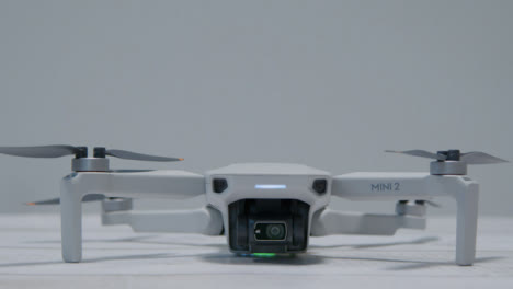 Pedestal-Shot-of-DJI-Mini-2-Drone-Sitting-On-Table