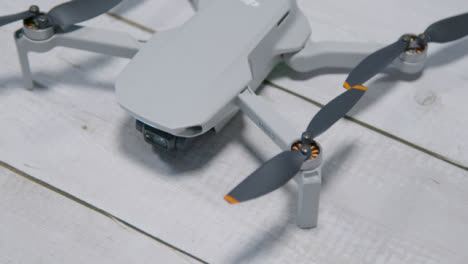 High-Angle-Shot-of-DJI-Mini-2-Drone-Sitting-On-Table