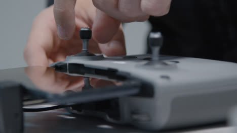 Close-Up-Shot-of-Person-Inserting-Joysticks-into-DJI-Drone-Controller