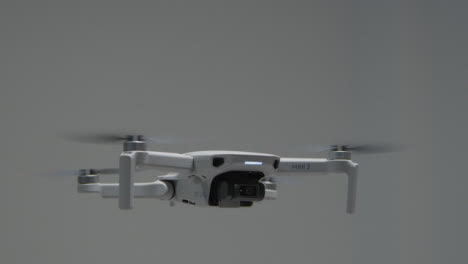 Tracking-Shot-Orbiting-DJI-Mini-2-Drone-Hovering-as-Gimbal-Adjusts