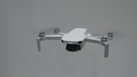 High-Angle-Shot-of-DJI-Mini-2-Drone-Hovering-In-Air