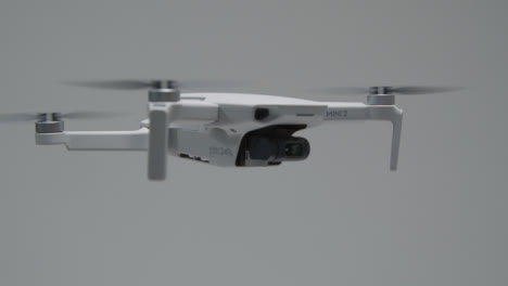 Pedestal-Shot-Following-DJI-Mini-2-Drone-During-Landing