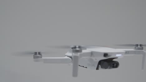 Pedestal-Shot-Following-DJI-Mini-2-Drone-During-Landing