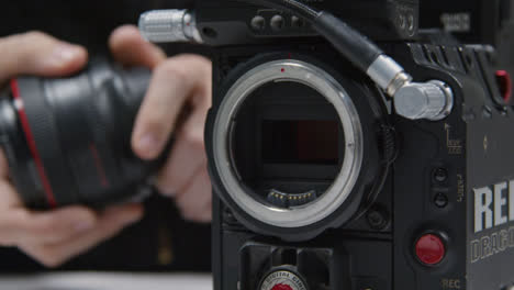 Close-Up-Shot-of-Person-Putting-Lens-On-RED-Dragon-Cinema-Camera