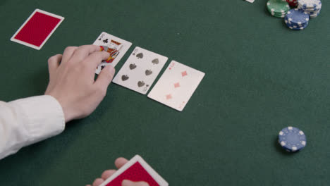 Over-the-Shoulder-Shot-of-a-Poker-Dealer-Drawing-Flop