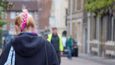 Tracking-Shot-Following-Person-with-Pink-Hair-In-Street