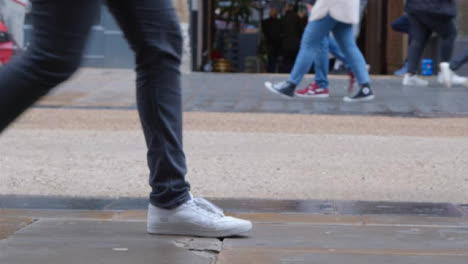 Wide-Shot-of-Pedestrians-Feet-Walking-On-Pavement-