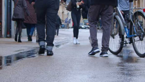 Sliding-Shot-of-Group-of-Pedestrians-Walking-Down-City-Street