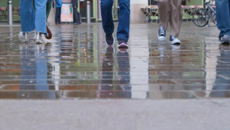 Tracking-Shot-Orbiting-Around-Pedestrians-Feet-Walking-In-Rain