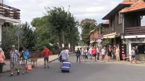 Nessebar-Bulgaria-street-tourist-pulling-suitcase