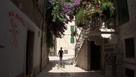 Split-Croatia-woman-walking-past-flowers