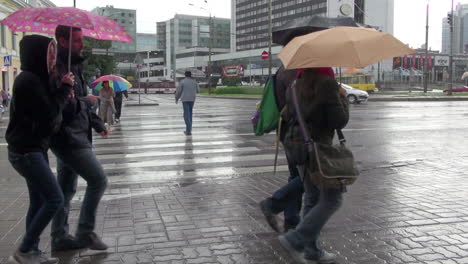 Tallinn-Estonia-on-a-rainy-day-with-green-bus-and-umbrellas