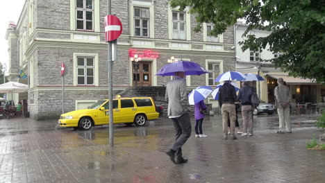 Tallinn-Estonia-on-a-rainy-day-with-people-and-a-yellow-taxi