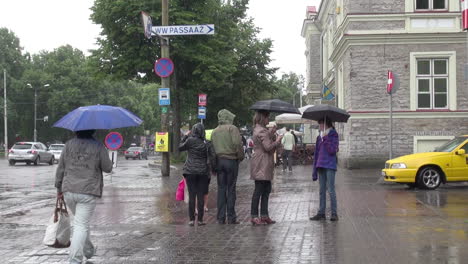 Tallinn-Estonia-pedestrians-on-a-rainy-day-and-a-red-bus
