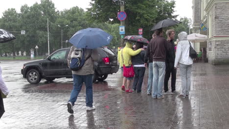 Tallinn-Estonia-people-with-umbrellas-cross-the-street