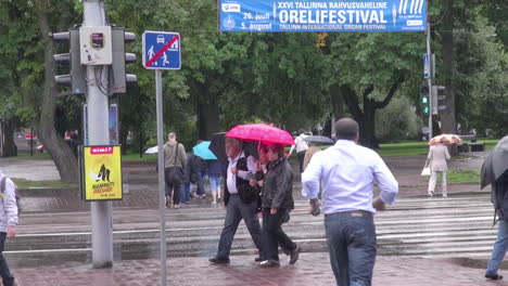 Tallinn-Estonia-people-with-umbrellas-walking-and-running-in-rain