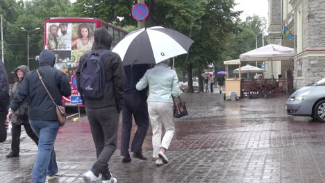 Tallinn-Estonia-people-with-umbrellas-walking-in-the-rain