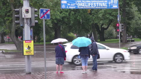 Tallinn-Estonia-people-with-umbrellas-watching-traffic