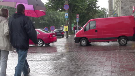Tallinn-Estonia-red-van-and-car-and-people-with-umbrellas