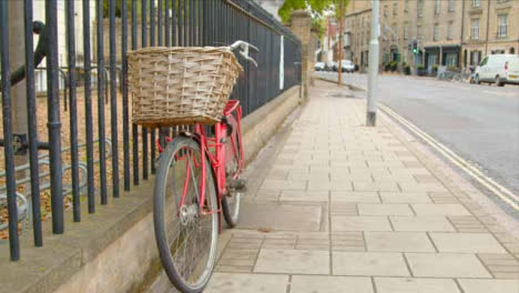Tracking-Shot-Orbiting-Red-Bicycle-Tied-to-Railing