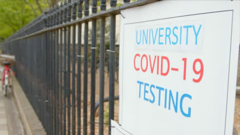 Close-Up-Shot-of-Covid-19-Testing-Centre-Sign-On-Metal-Railing