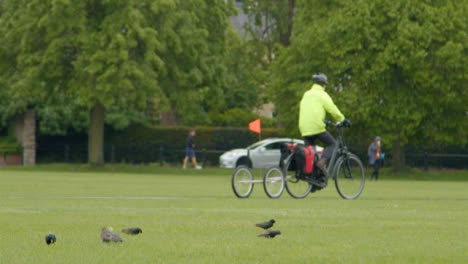 Long-Shot-of-Cyclist-In-Park